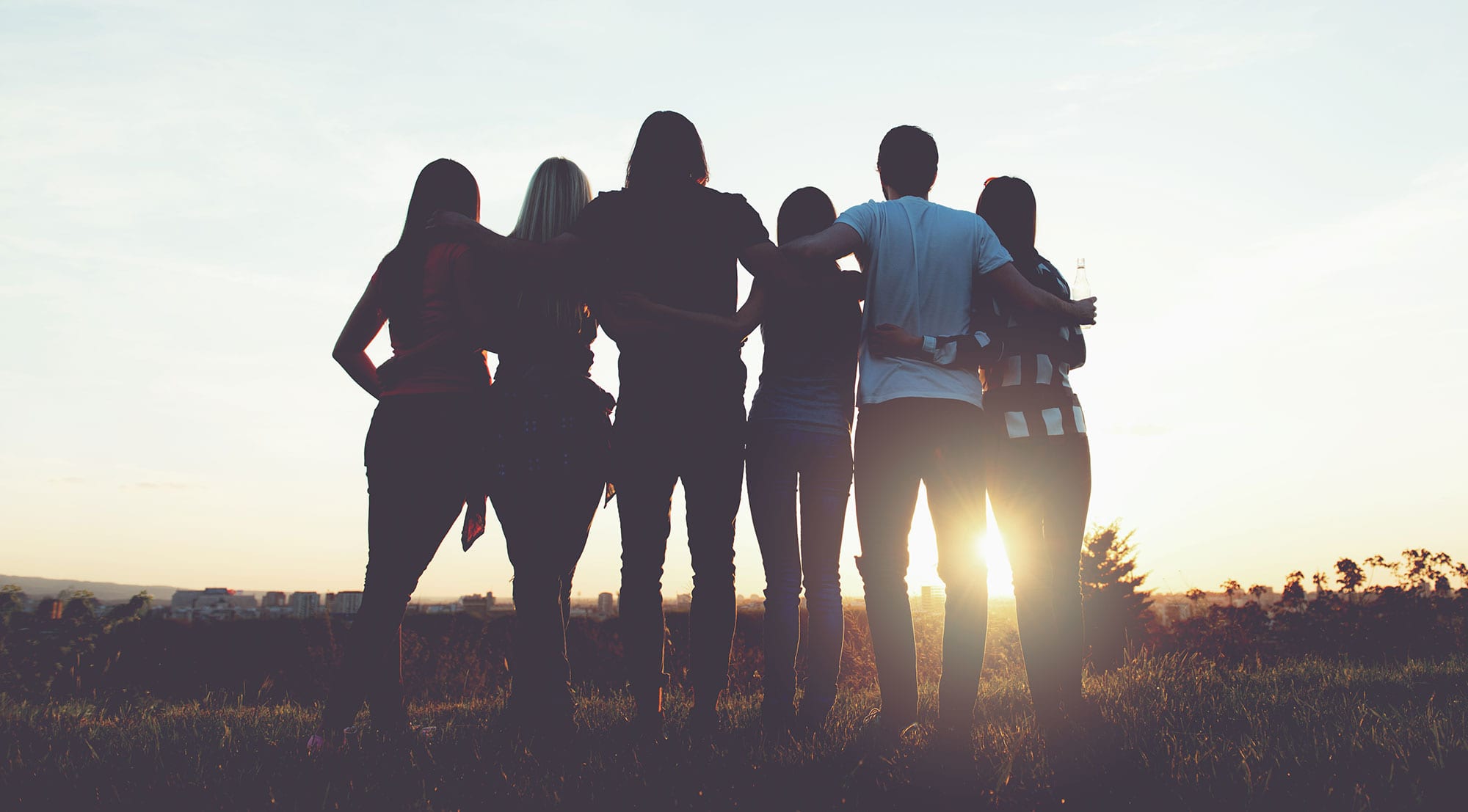 Group of people watching the sunset together